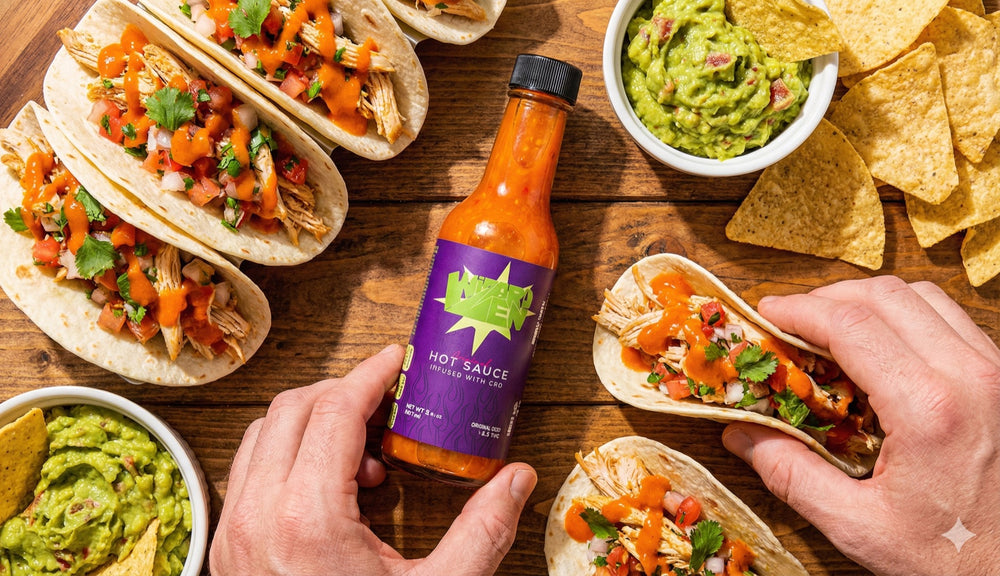 Wizard Zen hot sauce on a table of tacos
